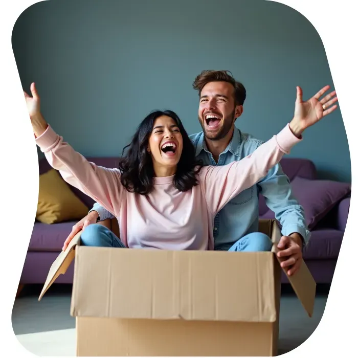 Two guys sitting on the floor of their apartment with Muval moving boxes